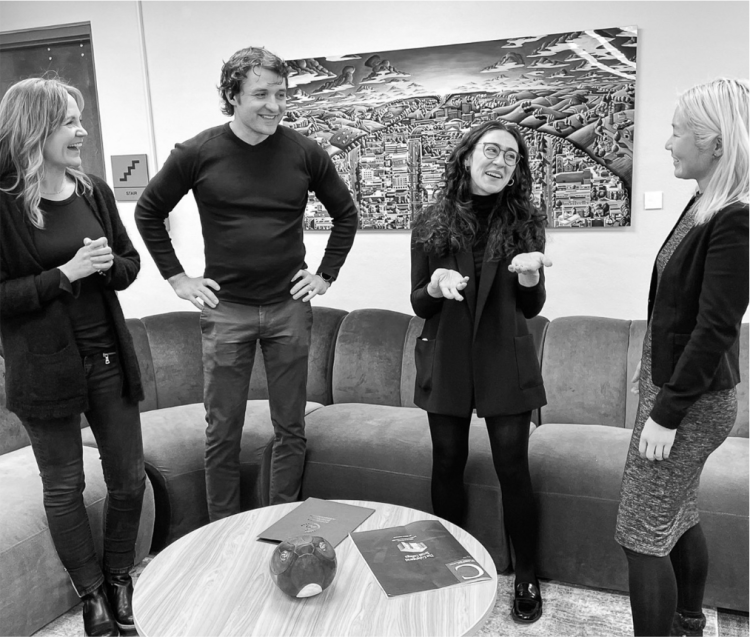 Group of four people talking