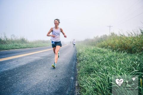 Oksana Loginova, Associate Professor of Economics, is running on a rural road during the 2019 Heart of America Marathon near Columbia, Missouri